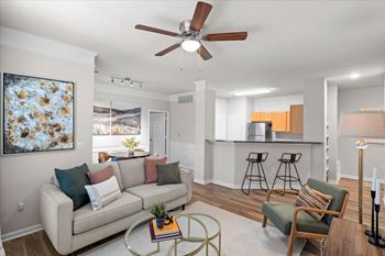 Spacious decorated living room with ceiling fan